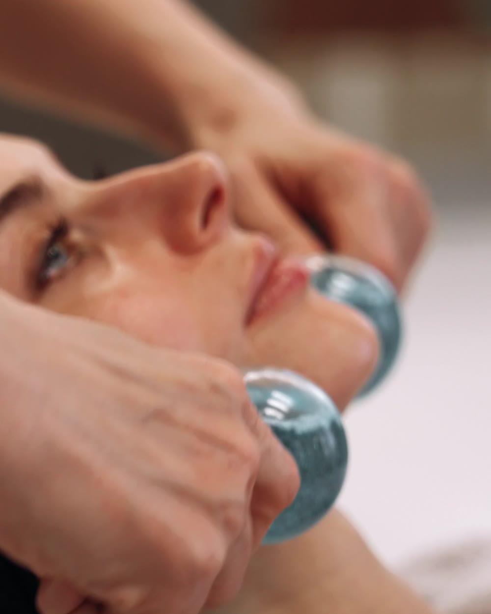 Chilled globes lifting a client's jawline